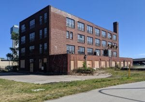 25-Year-Old Quad-Cities Artist Creating Massive Mural on Moline Spiegel Building