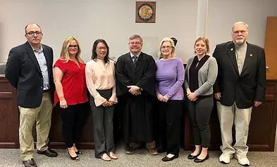 A group of CASA volunteers with Judge Ted Kutsunis.