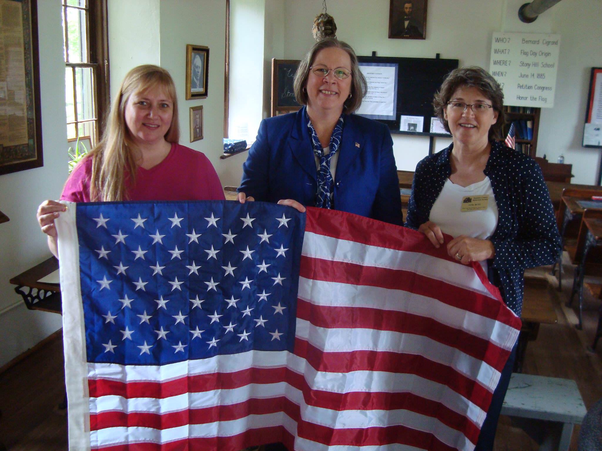 Moline filmmaker Tammy Rundle, left, with two organizers of a Flag Day ceremony in Wisconsin in 2009.