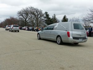 John VanDeWoestyne's hearse processes through the Richmond Hill Barn Theatre parking lot, March 31, 2020.