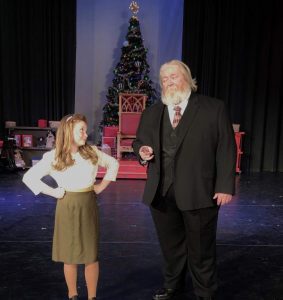 John as Kris Kringle, with Avie Birdsell in "Miracle on 34th Street" at the Spotlight Theatre in 2019.