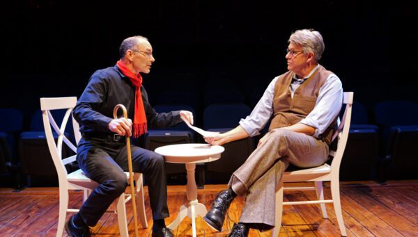 Timothy Cratchit (played by Jason Schaad) urges Sherlock Holmes (Tom Akers) to investigate the suspicious death of the good man, Ebeneezer Scrooge, in "A Sherlock Carol."