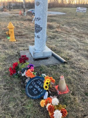 Flowers and a pole decal memorialize past crashes at the Kimberly-Fairmount intersection in Davenport, which saw two fatalities and four serious injuries between 2018 and 2022 (photo by Jonathan Turner).