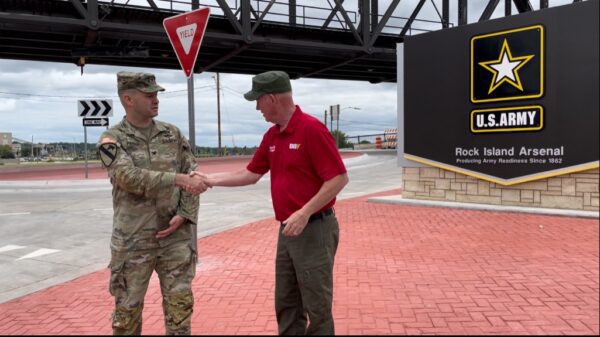 A new Davenport roundabout opened at the base of the Government Bridge in August 2024, celebrated here by then-Mayor Mike Matson (right) and Arsenal commander Col. Joe Parker (credit: City of Davenport).