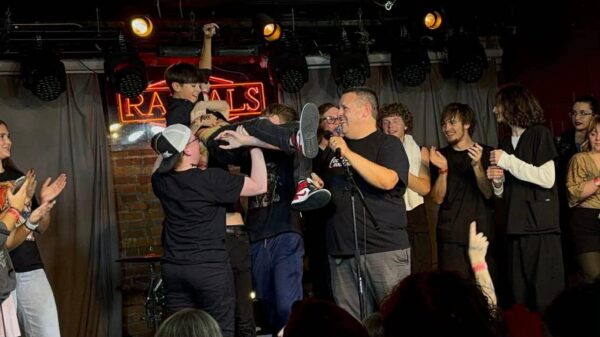 QC Rock Academy director Greg Hipskind celebrates with the band 7 Ark, after learning they won the upper division for Battle of the Bands at Rascals, Moline, in November 2025.