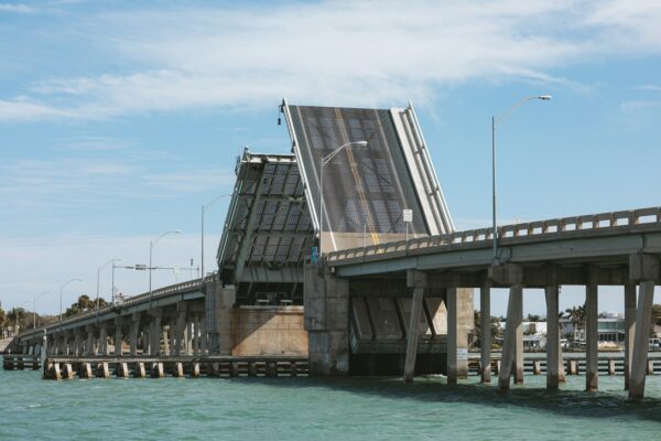 a bridge that is over water with a sky background