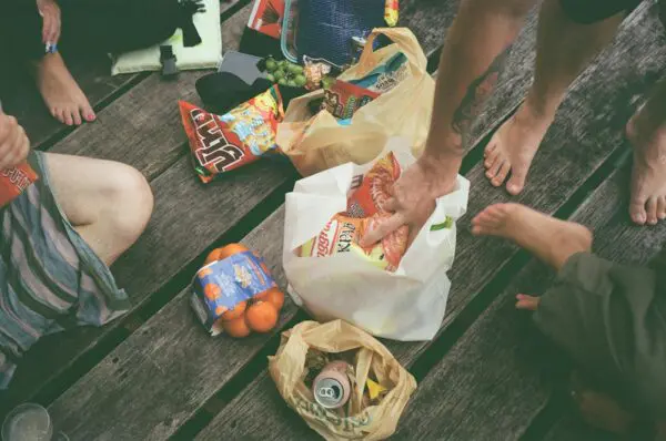 a group of people sitting on a wooden bench