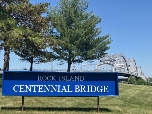 A Centennial Bridge sign near the Rock Island entrance to the 86-year-old bridge. (photo by Jonathan Turner).