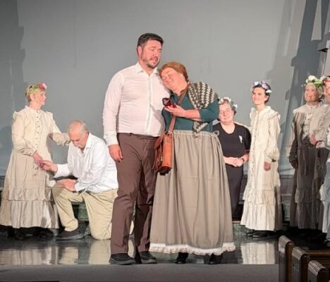 Patrick Downing (Angus Tuck) and Dawn Hickenbottom (Mae Tuck) surrounded by members of the ensemble.